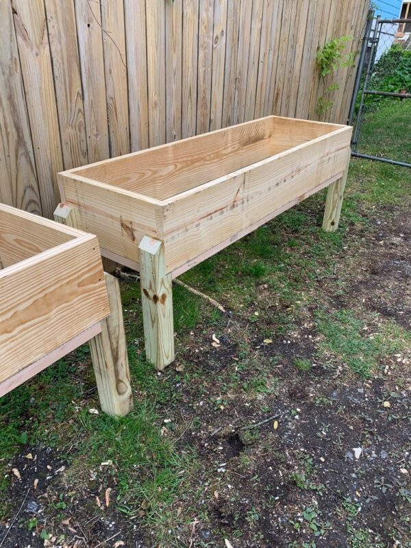 Raised garden planter with strong pressure treated legs and garden safe planter box.