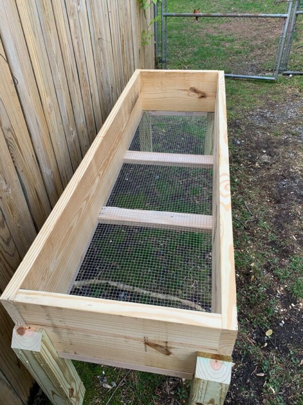 View of interior mesh screen of raised garden planter.