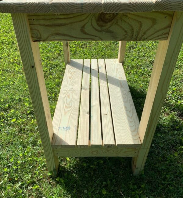 Detailed view of potting table slatted shelf.